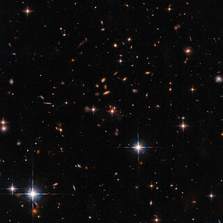 Wide Field Hubble View of Extremely Red Quasar SDSS J165202.64+172852.3
